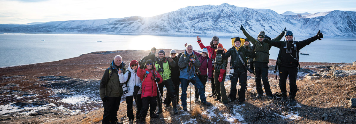 passengers smiling for group photo on hiking trails