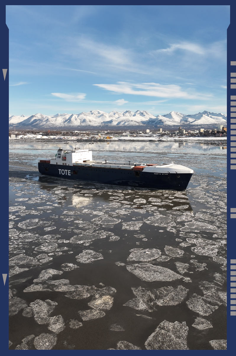 snap shot of a large Tote barge sailing in glacial water