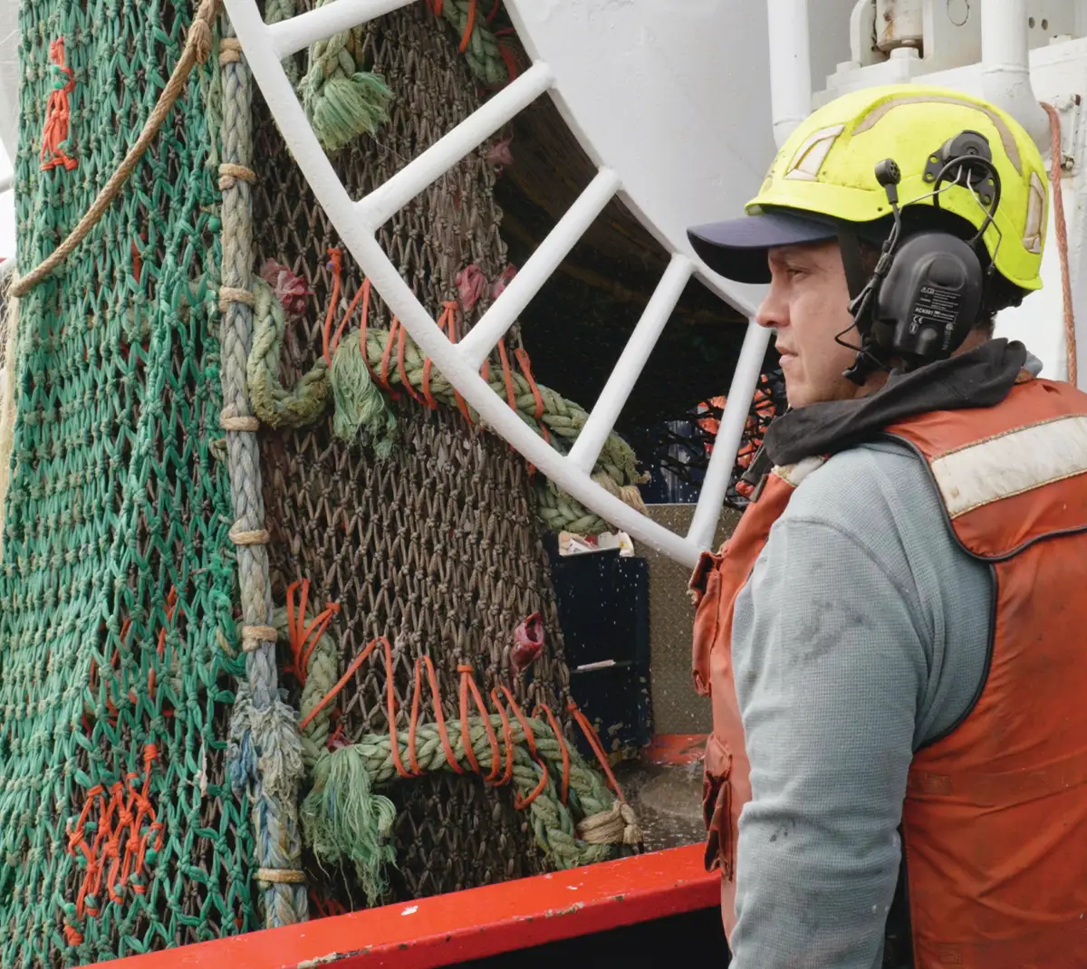 worker on a trawler hauling in a pollock net