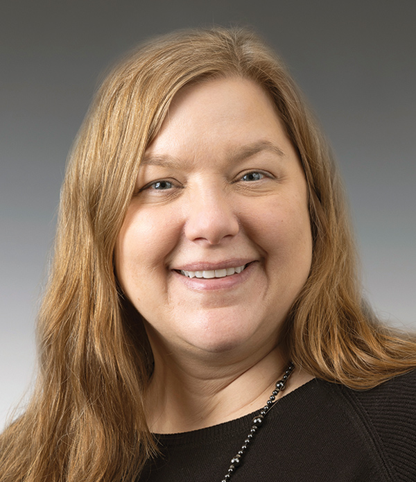 Portrait orientation close-up headshot photograph of Jennifer Segelhorst smiling