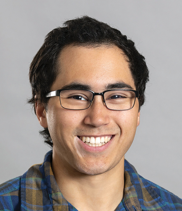 Portrait orientation close-up headshot photograph of Obadiah Dawson smiling