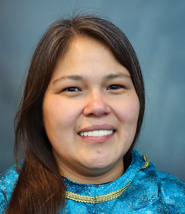 Portrait orientation close-up headshot photograph of Stevi Angasan smiling