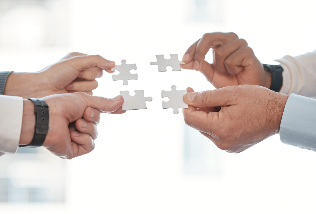 hands holding puzzle pieces together