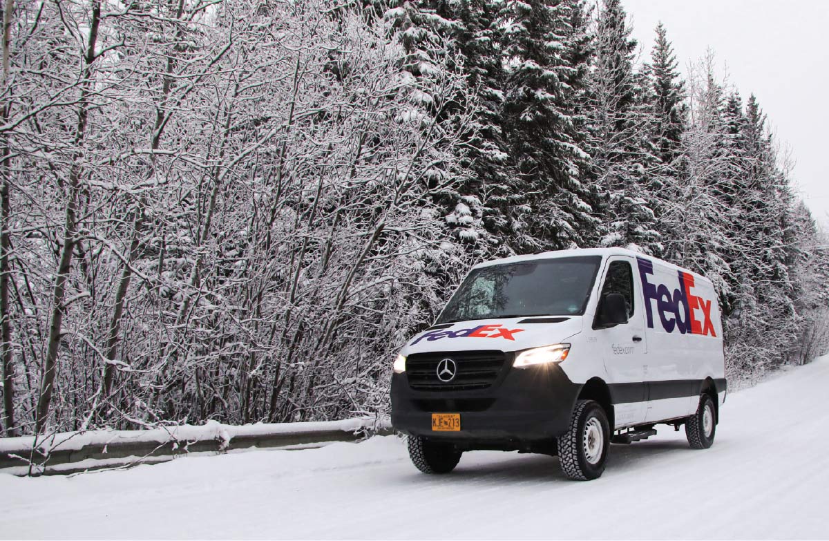 FedEx van driving through snow