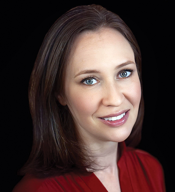 Portrait orientation close-up headshot photograph of Erica Drahozal smiling