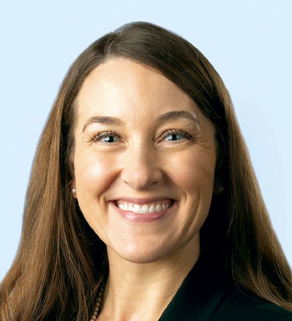 Portrait orientation close-up headshot photograph of Heather Tash smiling