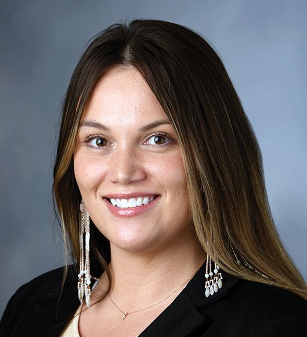 Portrait orientation close-up headshot photograph of Jordan Sanford smiling