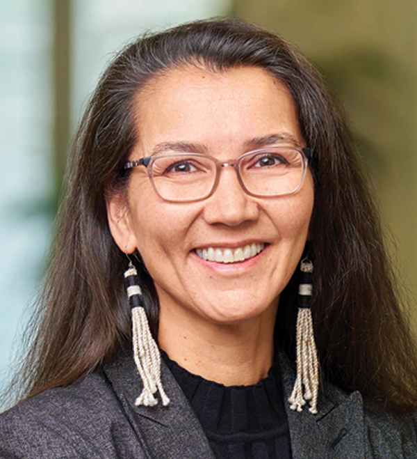 Portrait orientation close-up headshot photograph of Mary Peltola smiling