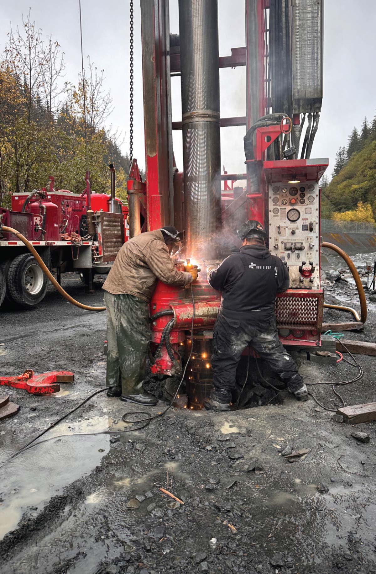 Two Sullivan Water Wells workers welding and installing telescoping screens