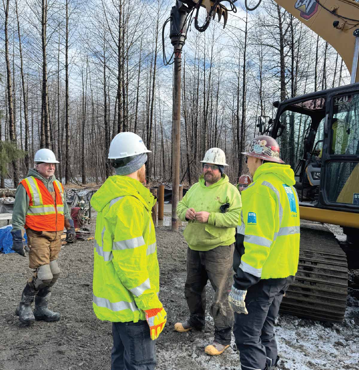 GCI workers and contractors huddle in a group
