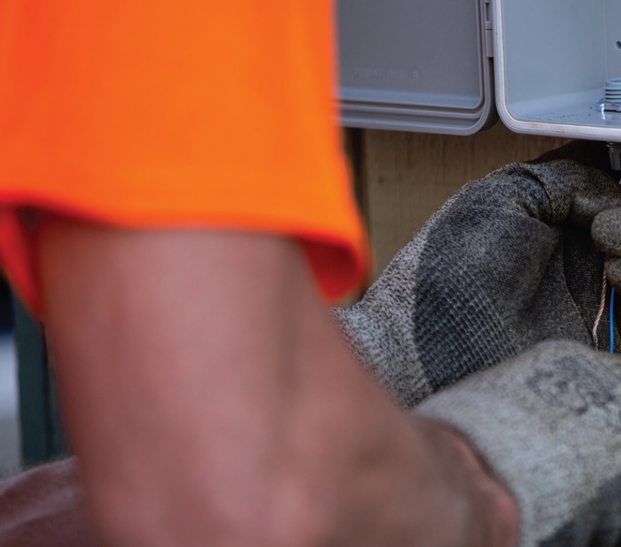 closeup of Alaska Communications technicians completing steps for fiber installation