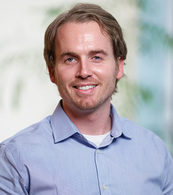 Portrait orientation close-up headshot picture view of James Delaney smiling