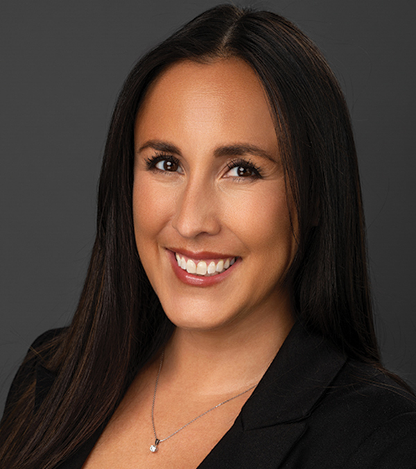 Portrait orientation close-up headshot picture view of Kim Sanderson smiling