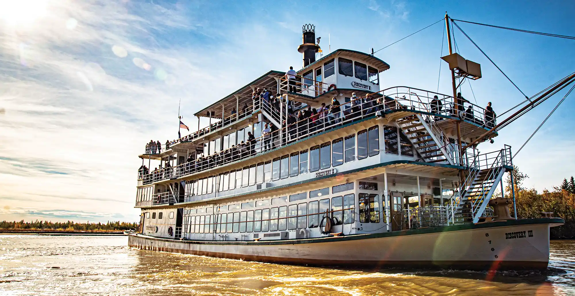 3/4 view of the Discovery river boat sailing in the water