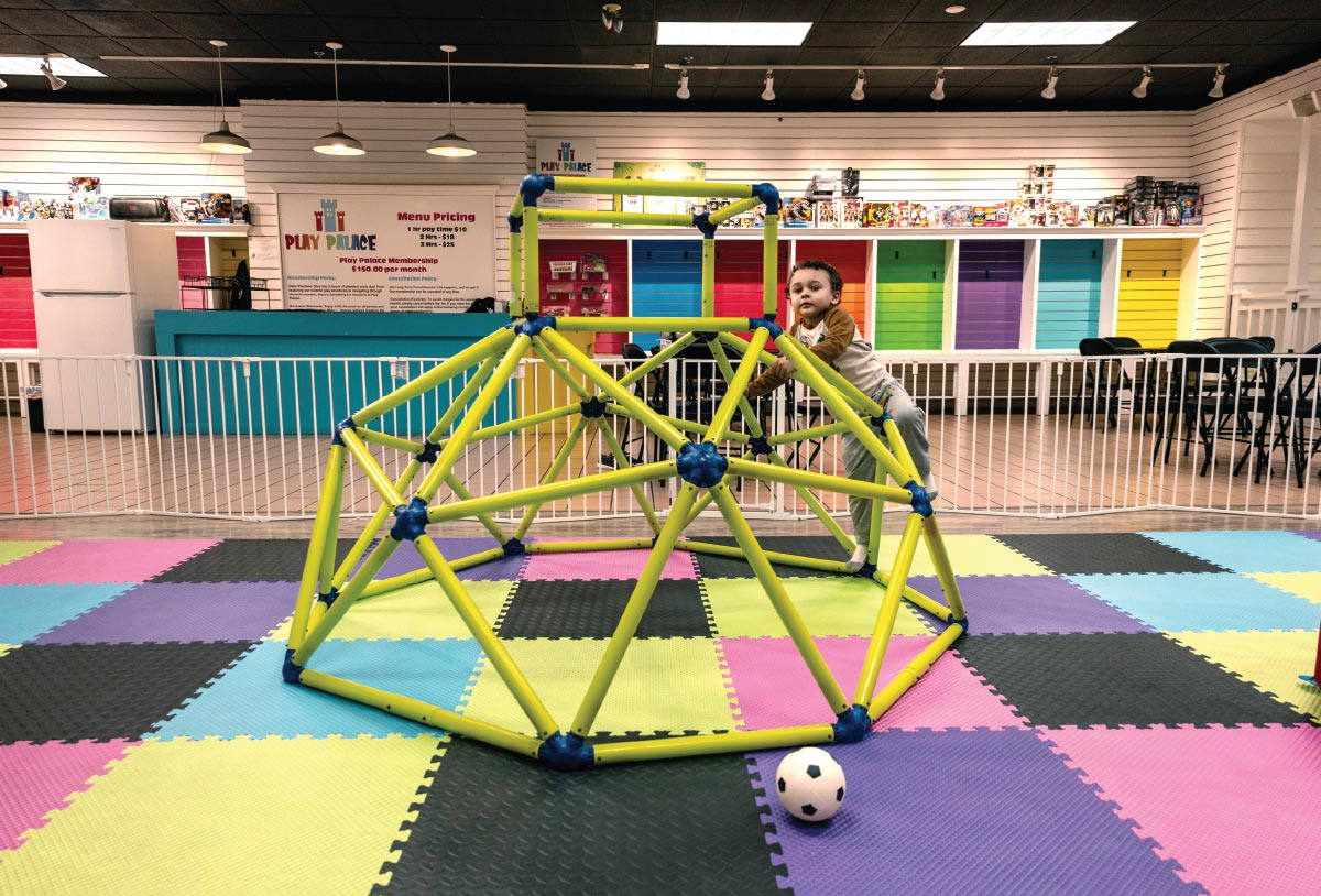 young child playing on climbing gym at Play Palace