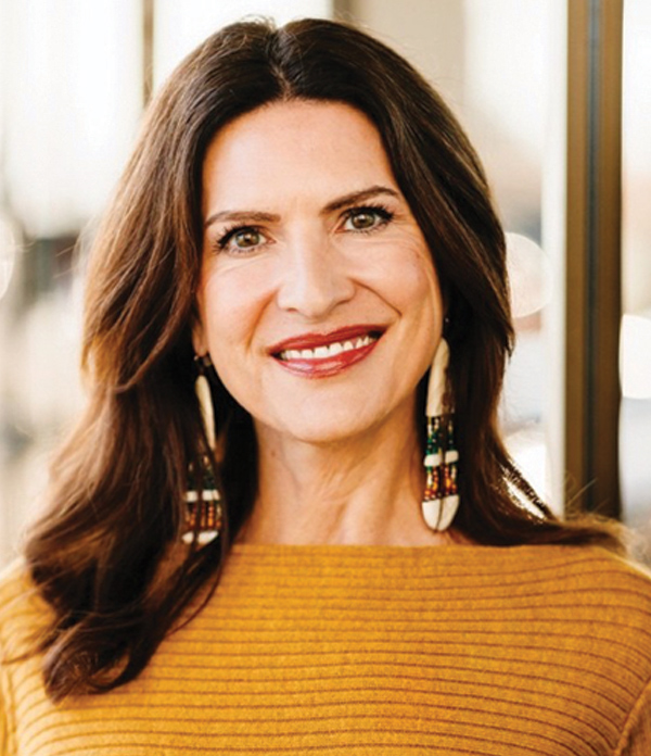 Portrait orientation photograph headshot of Kristina Woolston smiling