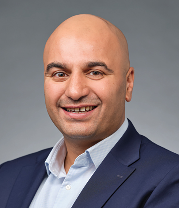 Portrait orientation photograph headshot of Mo Chahal smiling