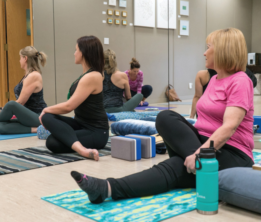three women on yoga mats
