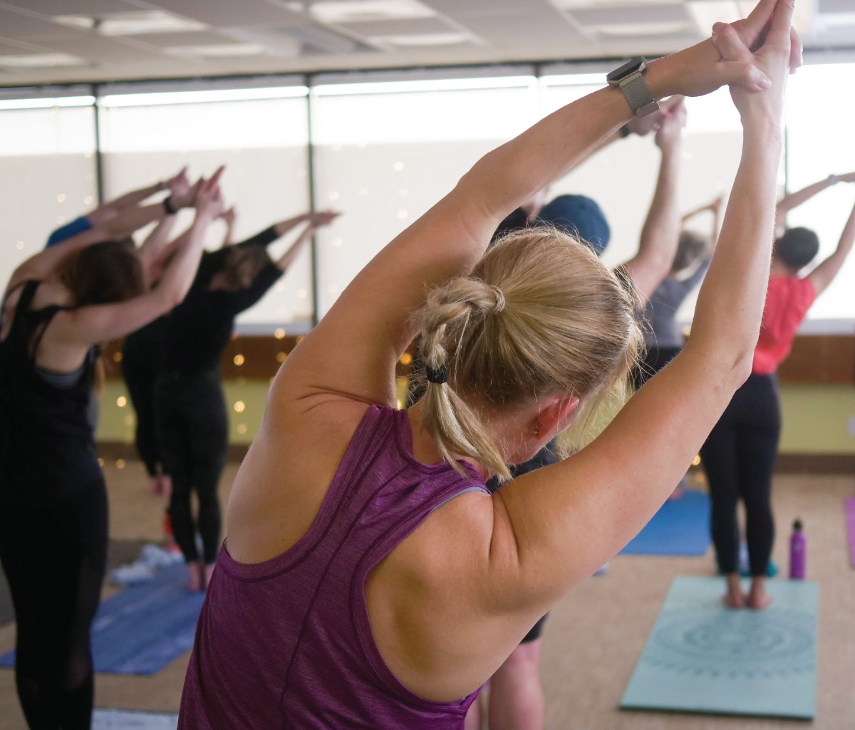The Alaska Club yoga students standing posing