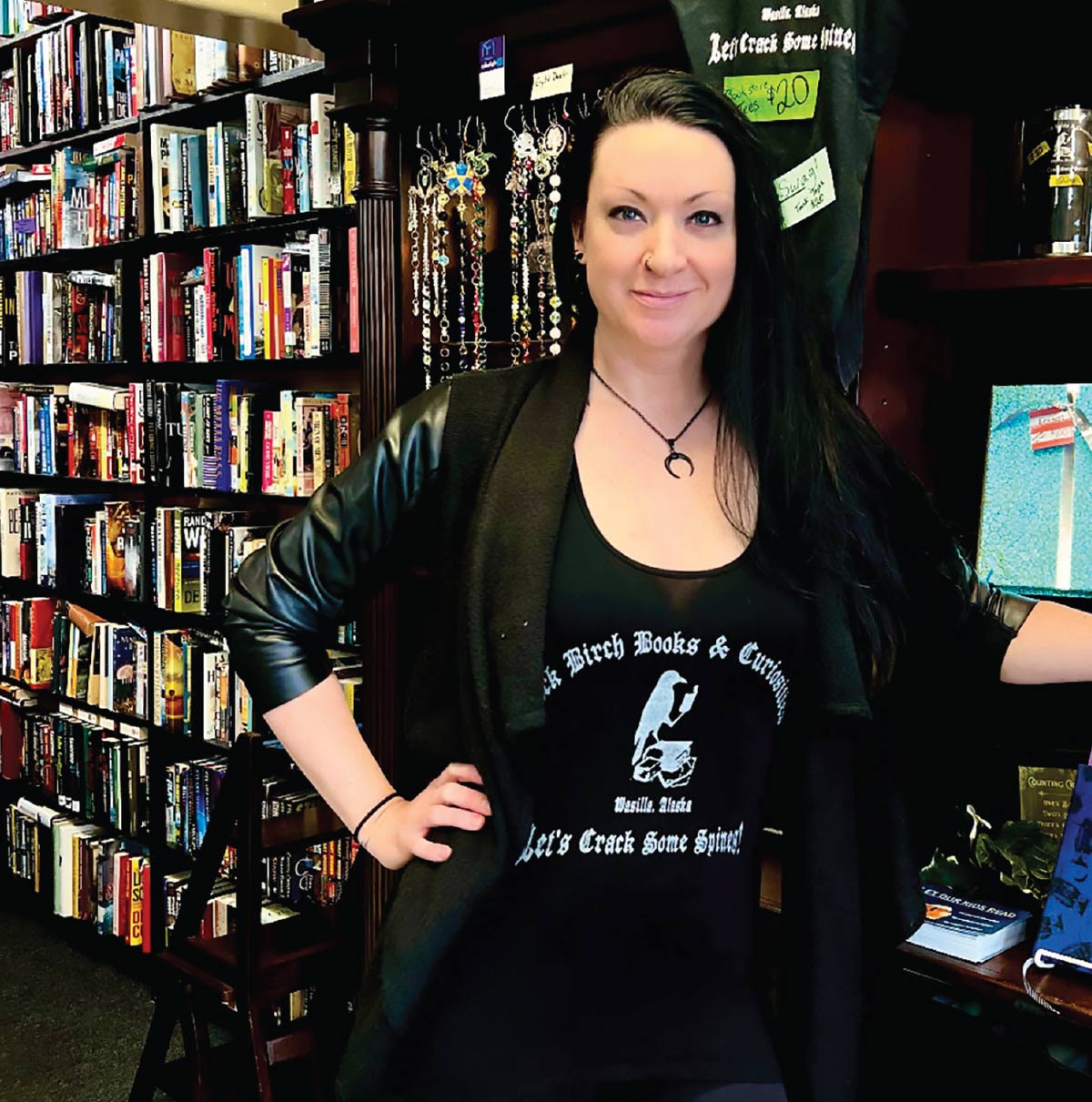 Taylor Jordan standing in front of book shelves at Black Birch Books