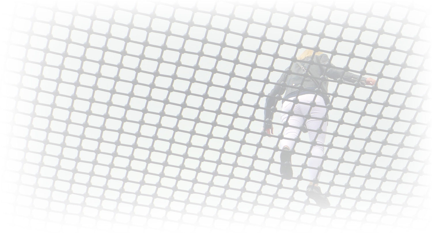  A person, viewed from behind and slightly below, walks on a large, taut net with square openings.
