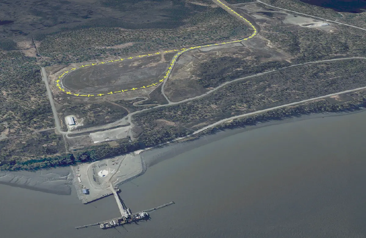 Overhead satellite view of Port Mackenzie showing its dock, industrial area, and extensive rail infrastructure with yellow-marked tracks winding through the landscape.