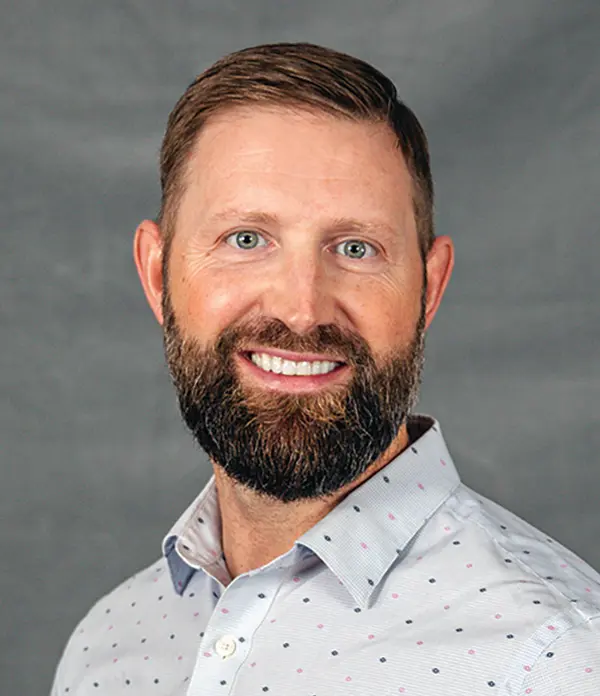 Portrait orientation photograph close-up headshot view of Dave Whitfield smiling