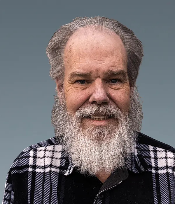 Portrait orientation photograph close-up headshot view of Kevin O'Shea smiling