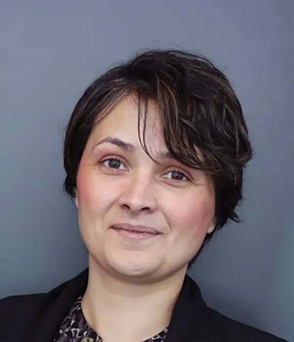 Portrait orientation photograph close-up headshot view of Lisa Andrus grinning