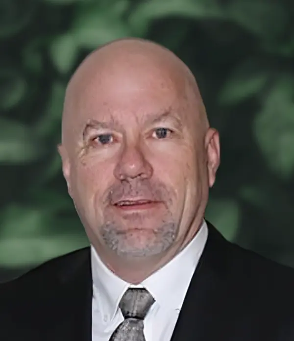 Portrait orientation photograph close-up headshot view of Todd Dahlman grinning