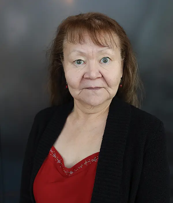 Portrait orientation photograph close-up headshot view of Anna Mae Bartholomew grinning