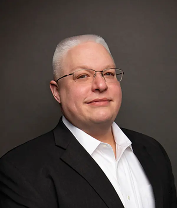 Portrait orientation photograph close-up headshot view of Ben Craig grinning