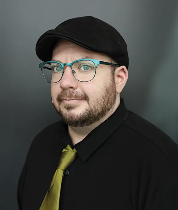 Portrait orientation photograph close-up headshot view of Dax Skratch grinning