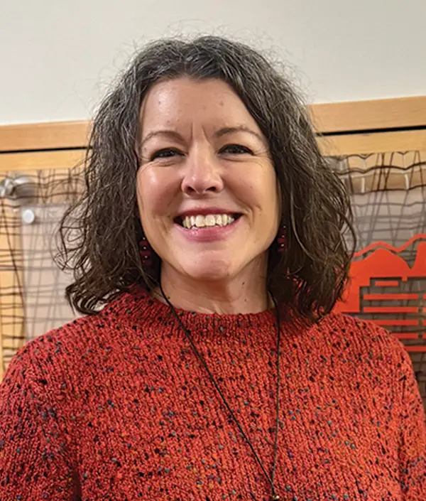 Portrait orientation photograph close-up headshot view of Laura Magstadt smiling