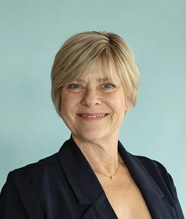 Portrait orientation photograph close-up headshot view of Lisa Morrow smiling