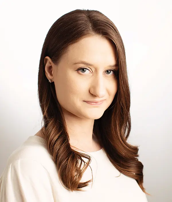 Portrait orientation photograph close-up headshot view of Nicole McVittie grinning