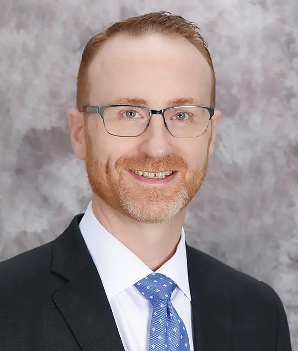 Portrait orientation photograph close-up headshot view of Paul Durkee smiling