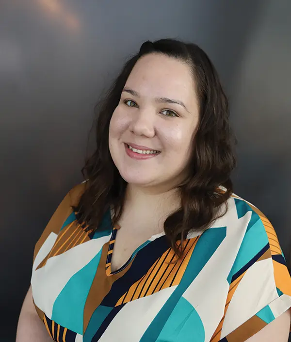 Portrait orientation photograph close-up headshot view of Tasha King smiling