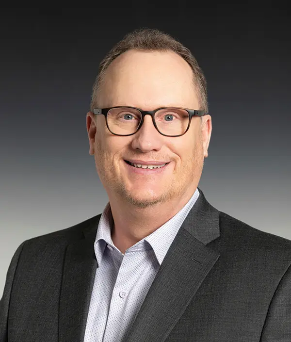 Portrait orientation photograph close-up headshot view of Todd Gilbert smiling