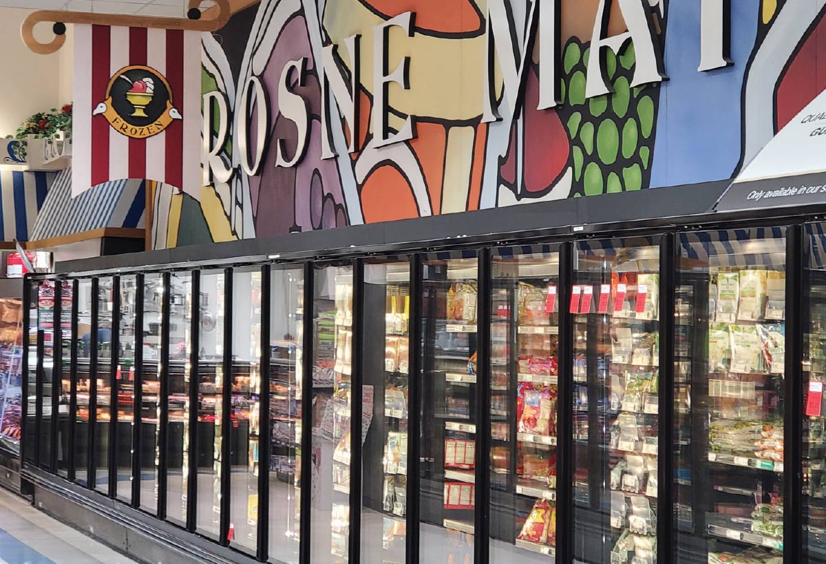 A close-up interior shot of the frozen food aisle of a grocery store. 
