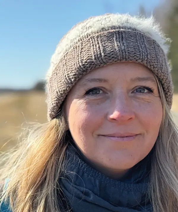 Portrait orientation photograph close-up headshot view of Cady Lister grinning