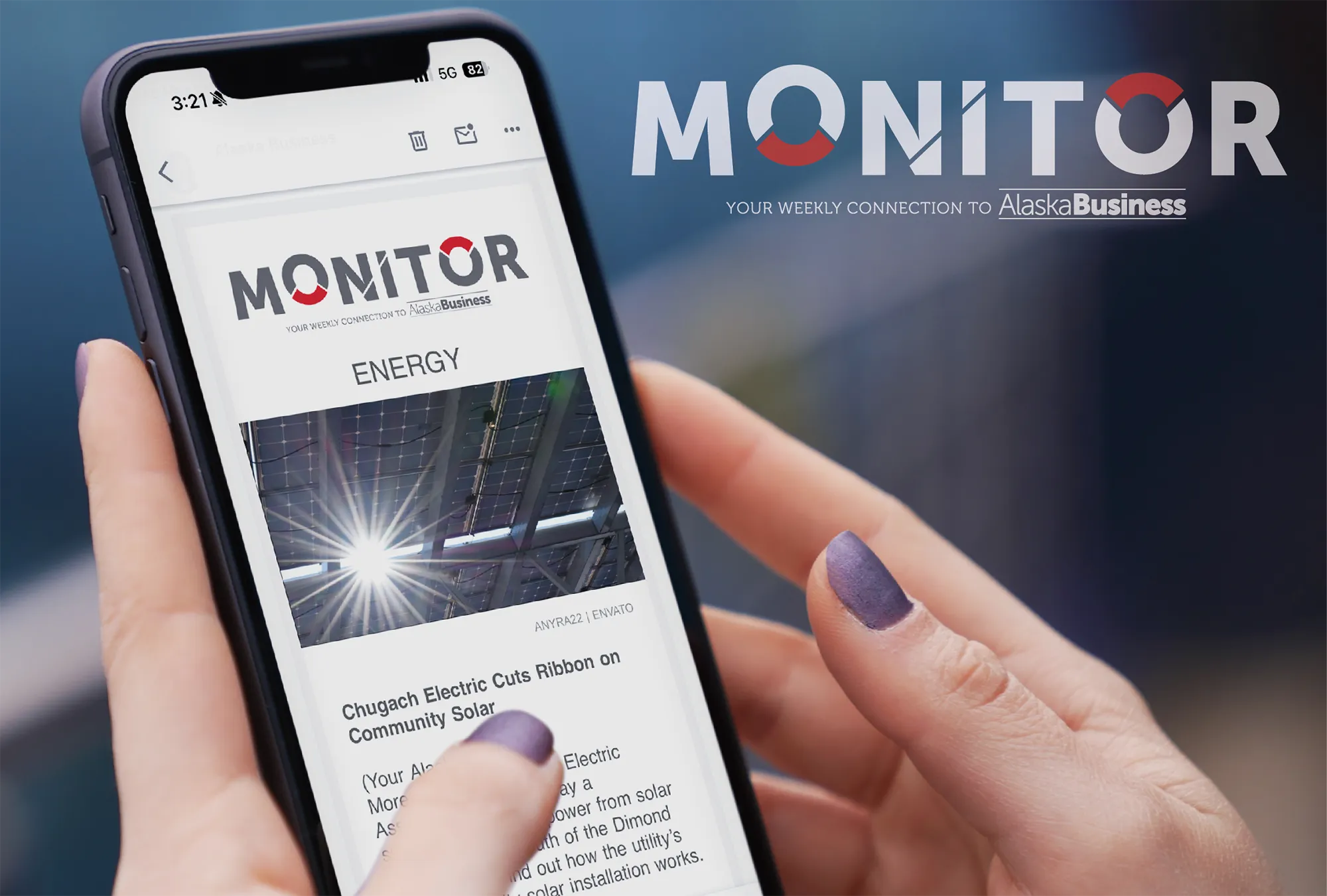 A person holding a smartphone displaying a newsletter from Alaska Business titled 'Monitor'. The newsletter highlights a business feature article along with an advertisement below it.