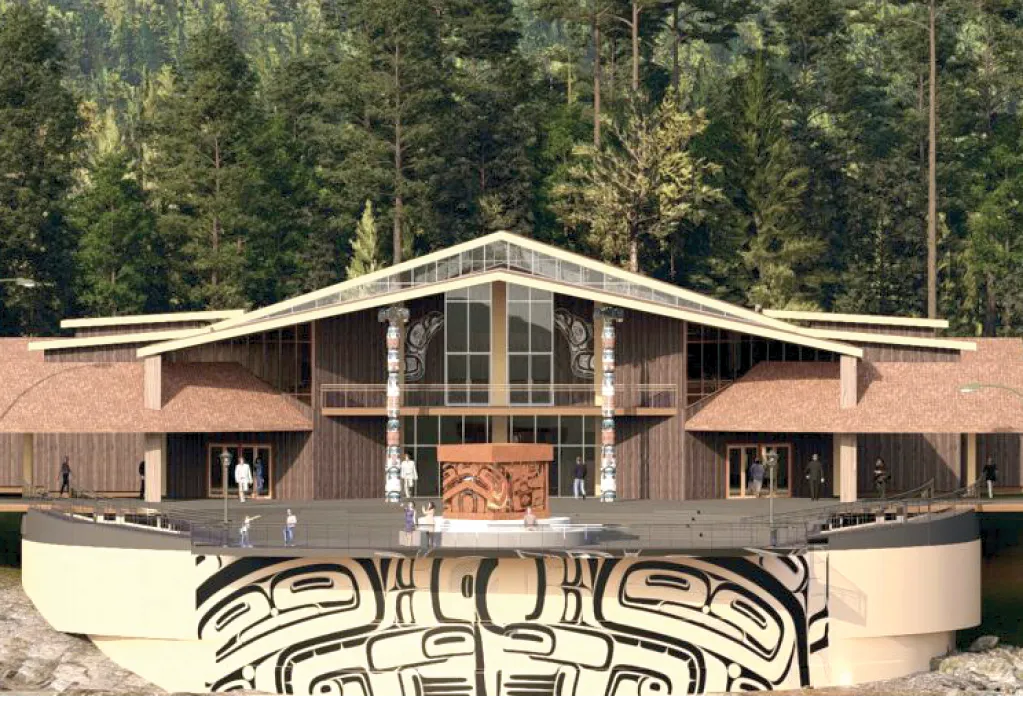 Modern building with a large deck, totem pole, and indigenous artwork, surrounded by tall trees.