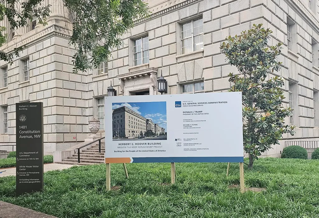 Sign for the Herbert C. Hoover Building, detailing a roof replacement project, with text and an image of the building.