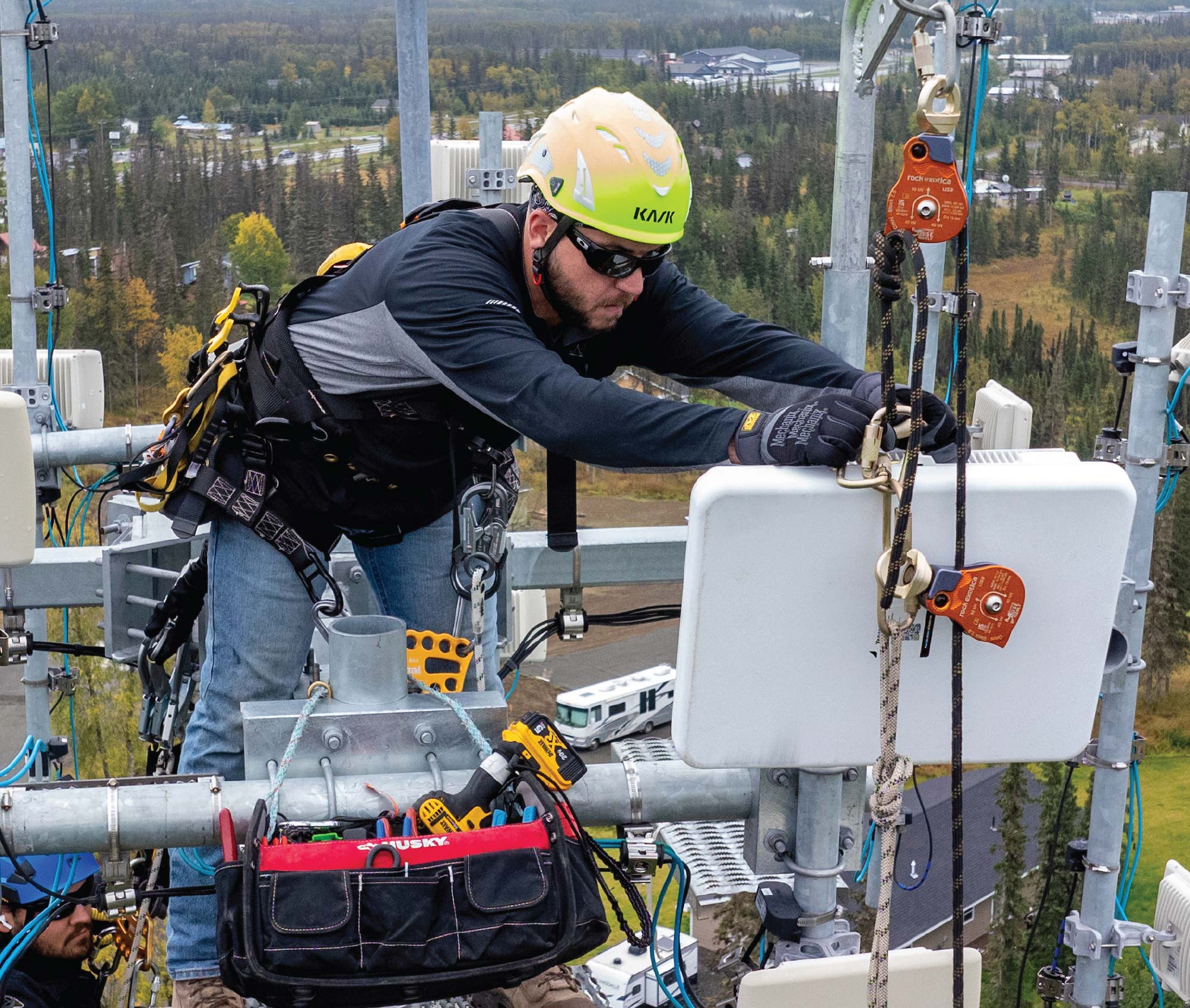 man on lift working on cables in front of him