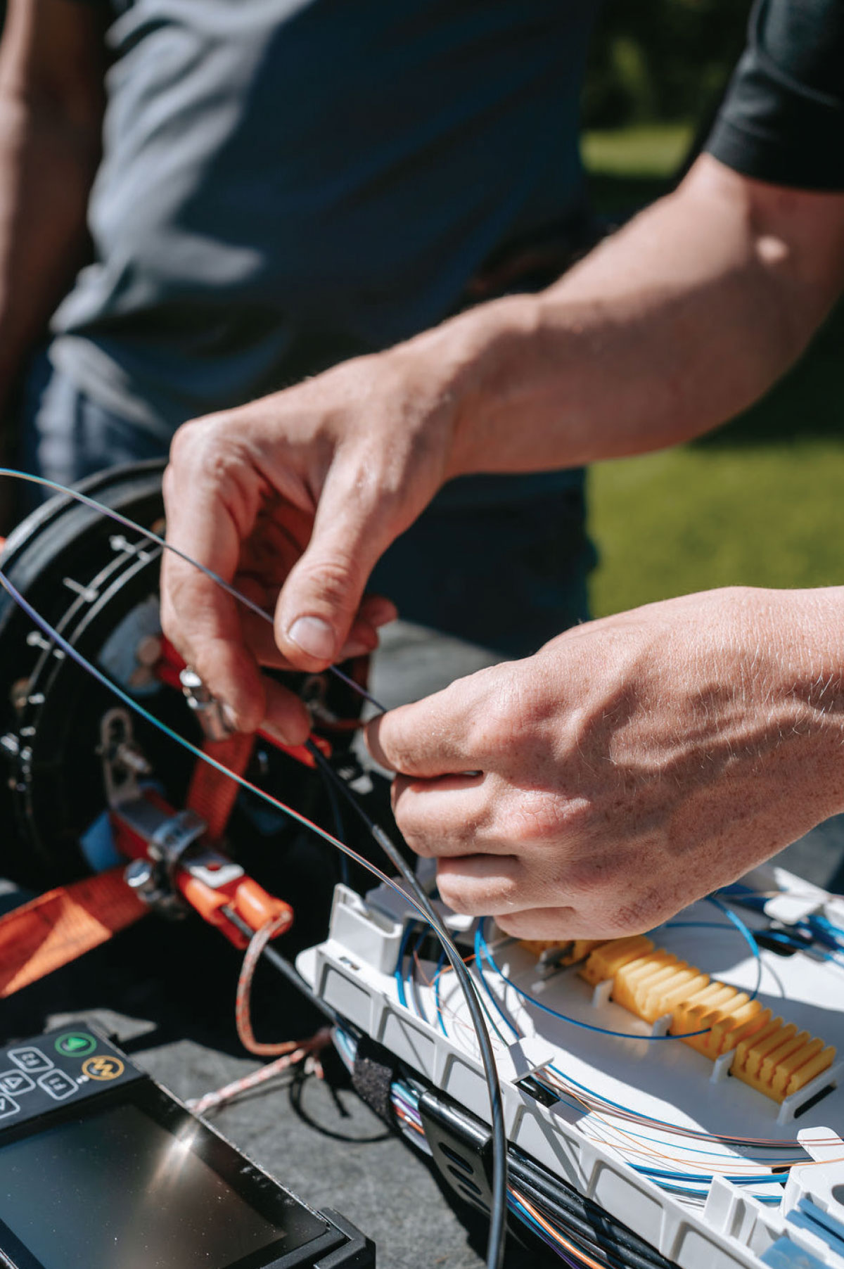 an Alaska Communications apprentice splicing fiber
