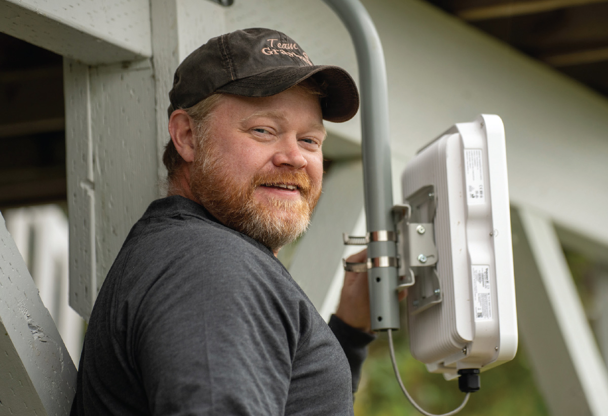 field technician foreman Travis Wetzel installing fixed wireless at a customer’s home