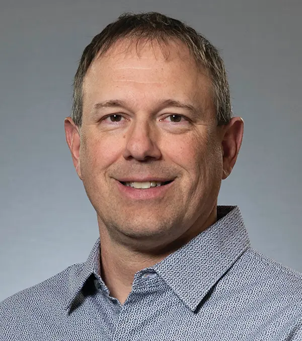 Portrait orientation photograph headshot close-up of Geoff Mittelsteadt smiling