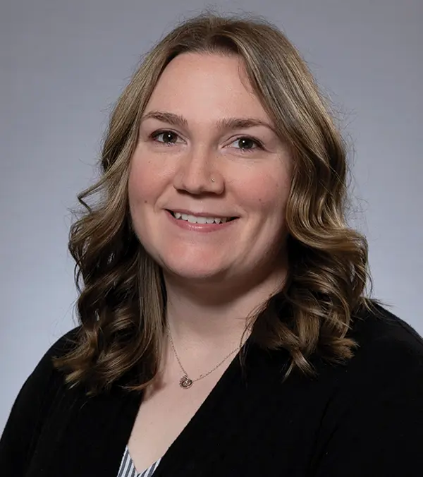 Portrait orientation photograph headshot close-up of Monica Lewis smiling