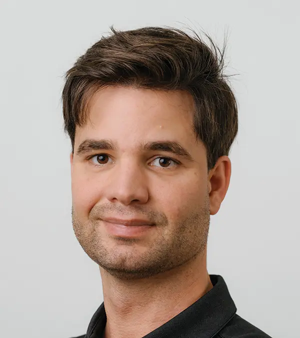 Portrait orientation photograph headshot close-up of Weston Giliam grinning